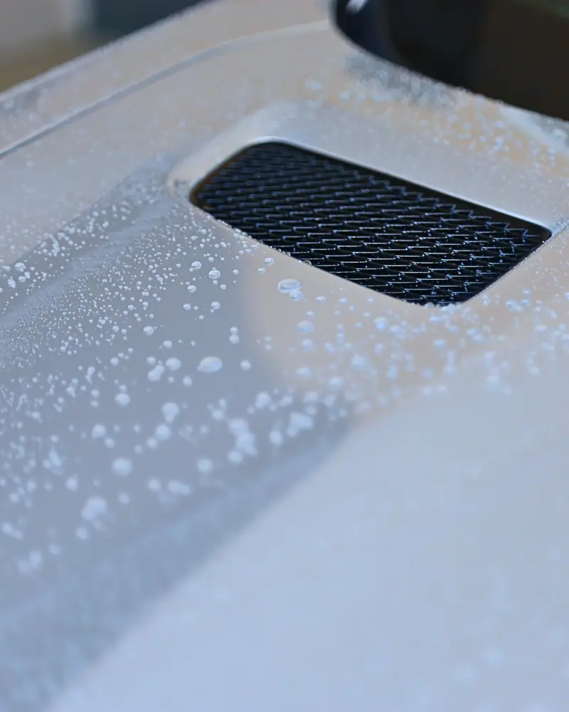 Water beading on a coated bonnet vent