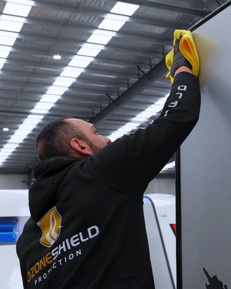 Technician treating a caravan surface